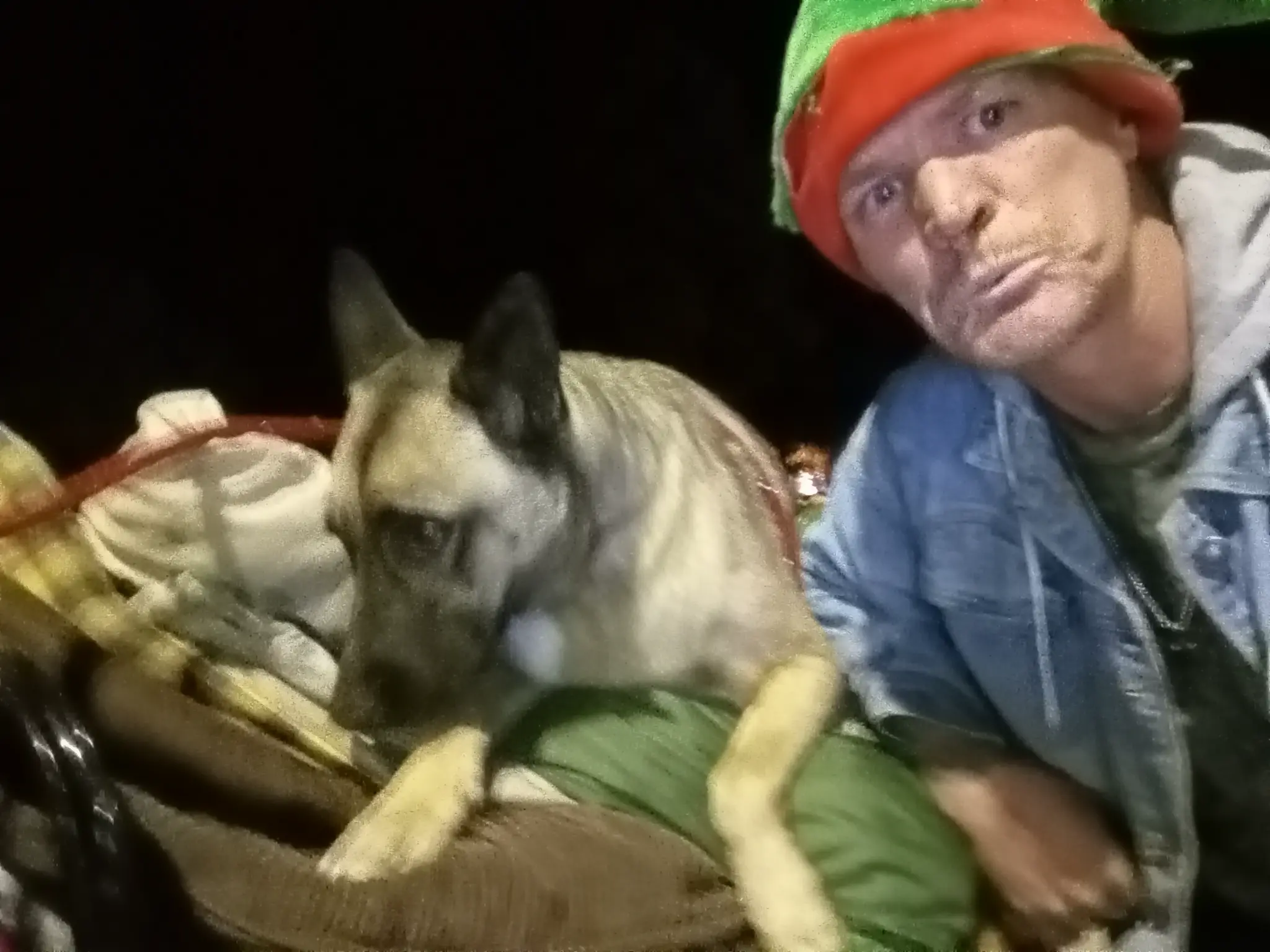 Matthew holding Cleopatra close at night on the streets